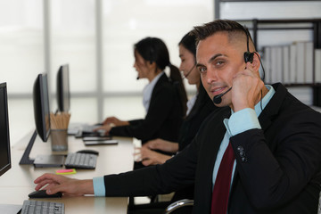 caucasian help desk and call center agent working at customer service operation center