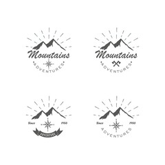 Black and white set of logos adventure and recreation in the mountains. Vector illustration of mountains, rays, crossed axes and text with ribbon. Advertising expeditions to the mountains.