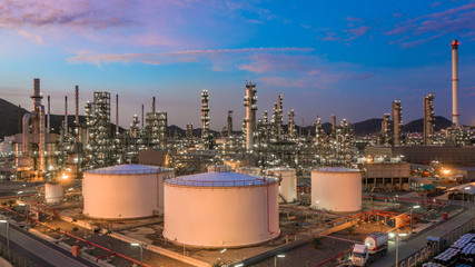 Oil​ refinery​ with oil storage tank and petrochemical​ plant industrial background at...