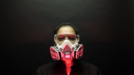 Coronavirus pathogen outbreak pandemic biohazard concept. Woman in heavy duty urban protective mask...