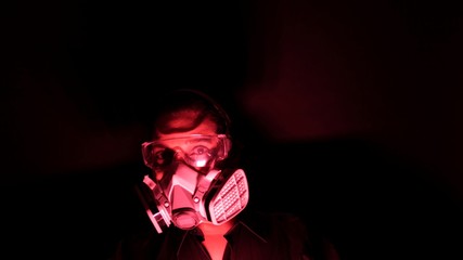 Coronavirus pathogen outbreak pandemic concept. Woman in urban protective or medical mask, looking at the camera on black background. Virus disease 2019-nCoV protection and prevention.