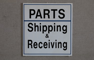 Sign indicating parts department and shipping & receiving
