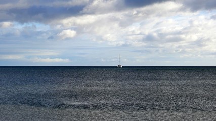 lonely sailboat on the sea while a storm is coming
