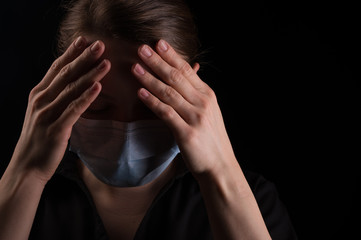 Coronavirus virus in 2020 flu, epidemic. Girl in a protection mask on a black background, Danger of the Chinese virus