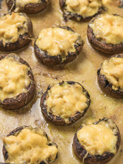 Background of baked mushrooms with chicken breast and cheese.