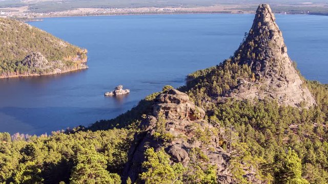 Epic view of Burabay lake with Okzhetpes and Zhumbaktas rocks from the highest point of Sinyuha Mountain at sunset in autumn season; time lapse