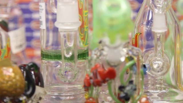 Pan over Numerous Glass Tobacco / Cannabis Pipes and Bongs Display