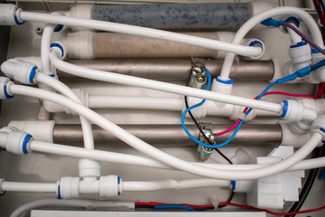 System of white plastic and metal tubes. Connecting elements. Electric wires. Concept of liquid or gas industrial equipment.