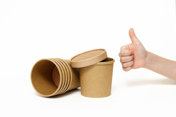 Eco kraft paper tableware. Fast food paper containers and children's hand isolated on white background. Recycling concept. Zero waste.