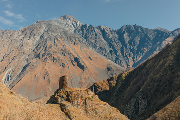 Fototapeta premium Landscape of Gergeti tower ruins on mount Kazbek trail in Stepansminda, Kazbegi, Georgia.