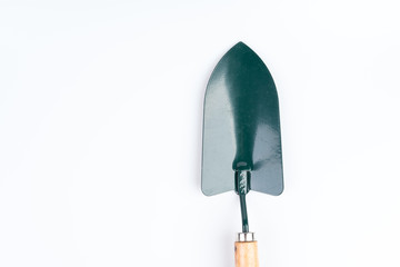 Green garden shovel with wooden handle
