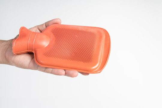 hand holding hot water bag for pain relief