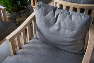 Fototapeta na wymiar Modern gray fabric cushion wooden chair interior decoration in living room