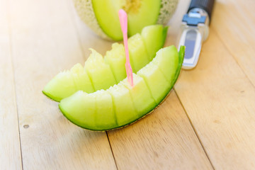 Fresh green melon on wood plate