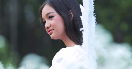 portrait of Asian girl wearing angel wings ,beautiful Asian girl smiling girl enjoying nature, girl with fields of flowers - Powered by Adobe