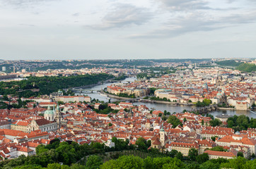 Fototapeta na wymiar Orange color roof houses with Charles bridge in the background in Prague Czech Republic