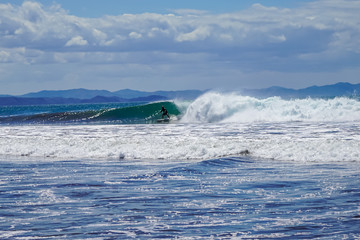 Naklejka premium Beautiful aerial view of surfers surfing in Naranjo Beach 
