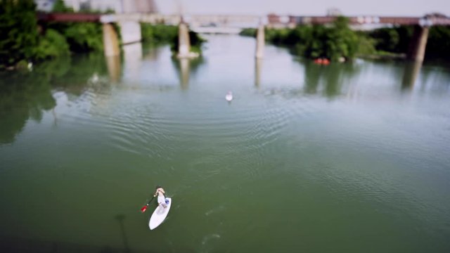 Tilt Shift World with tiny little boats, kayaks, and paddle boards. With the tilt shift lens, people and transportation are unrecognizable. Tiny little people enjoy the lake in Austin Texas