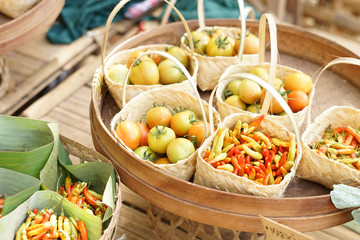 Fresh tomato and chili on small bucket bamboo sell in traditional market