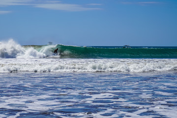 Fototapeta premium Beautiful aerial view of surfers surfing in Naranjo Beach 