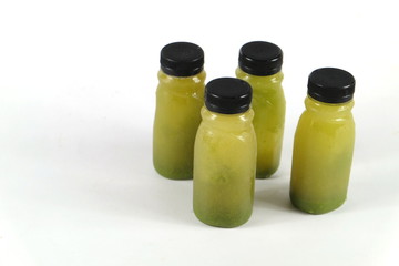 Healthy smoothie vegetables are chilled in many plastic bottles.