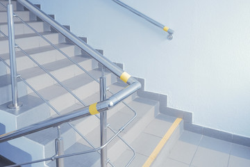 Stainless steel handrails for stairs for the disabled people.Yellow marking on handrails in the state organization for visually impaired people.Help for blind people.Selective focus.