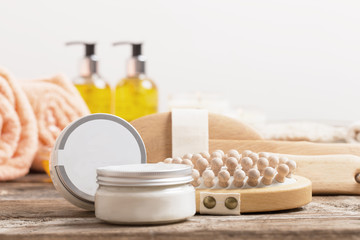 Cosmetic bottles  and towels on  wooden table indoor