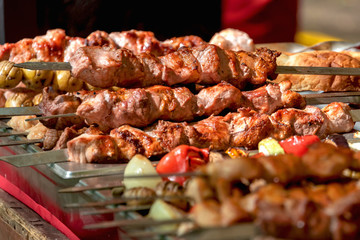 Fresh, homemade pork kebab with vegetables. Cooking on the fire. The meat on the grill.
