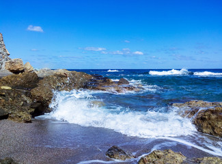 sea surf on the rocky coast and the beach 