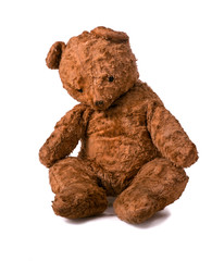 Unsightly sad vintage teddy bear. sitting on a white background.