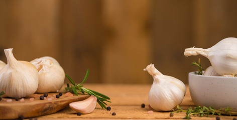 Banner with garlic and drunkenness on a wooden background, food and cooking saver, recipe book,...