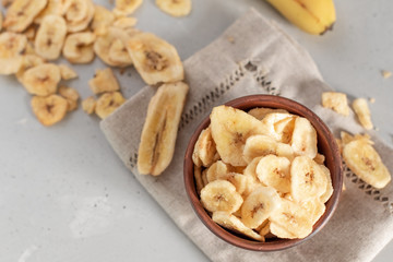 Banana - This is a close up shot of a bowl full of dried banana chips. Shot with a shallow depth of field and vignetting.