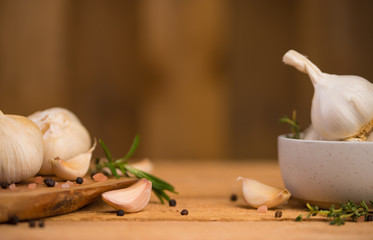 Garlic banner, background. Spices, Bulbs of garlic on a wooden rustic table in the shape of a panorama. A bunch of garlic peeled cloves