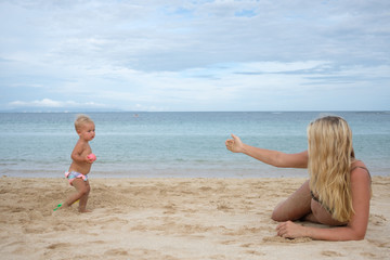 Pregnant mother and kid on the beach, happy mothers day