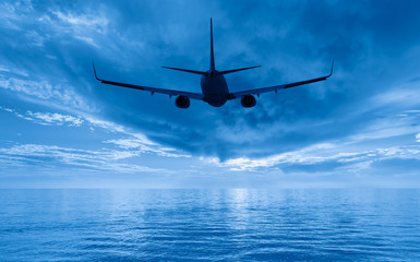 Airplane taking off from the airport - passenger airplane flying above tropical sea at amazing...