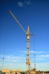 Fototapeta premium Tower cranes are working on the construction of a new house. Lifting crane.