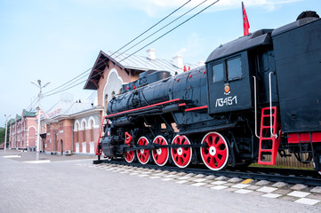Russia, Blagoveshchensk, July 2019: Monument of an old steam locomotive at the railway station of the city of Blagoveshchensk in the summer