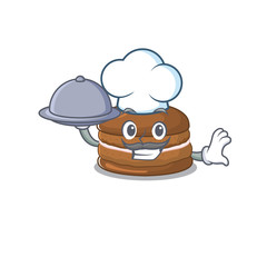 A picture of chocolate macaron as a Chef serving food on tray