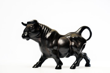 Black statuette of a muscular bull in profile i