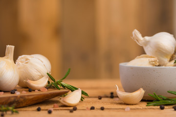 Spicy background of garlic and spices, rosemary, black pepper, and thyme. Concept of cooking, recipe book and home cooking.