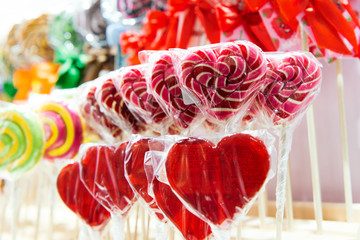 Red candies are arranged in even rows on a shop window.