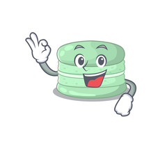 A funny picture of pistachio macaron making an Okay gesture