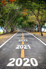 Tree tunnel with 2020 to 2026 on asphalt road surface, happy new year concept and natural idea
