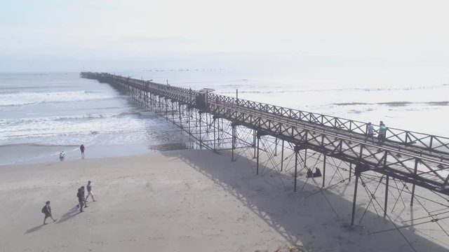 Aerial drone view move Pimentel Pier at a sunny day in Chiclayo city, Lambayeque Region, Peru