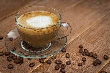 Cup of hot coffe with milk on a dark background. latte or cappuccino on a wooden table with copy space