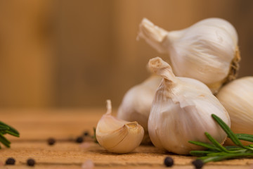 Garlic and spices on a wooden background, cooking saver