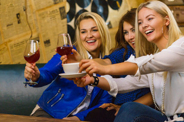 Happy girls in pub club having fun