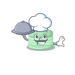 A picture of pistachio macaron as a Chef serving food on tray