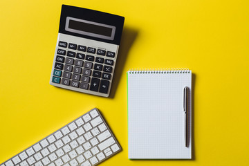 Top view of business working place with cup of coffee, Empty workspace on yellow table background.