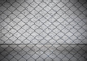 Fototapeta premium Wire fence with Old white brick wall background.
